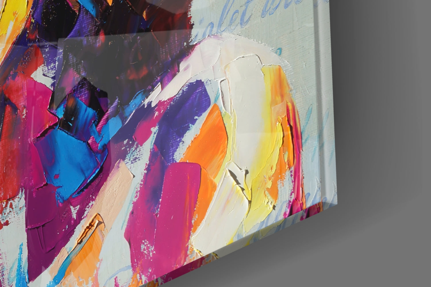 Close-up angled view of colorful abstract bohemian glass wall art with vibrant pink, purple, blue, yellow, and orange brushstrokes on white background.