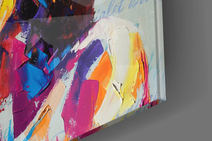 Close-up angled view of colorful abstract bohemian glass wall art with vibrant pink, purple, blue, yellow, and orange brushstrokes on white background.