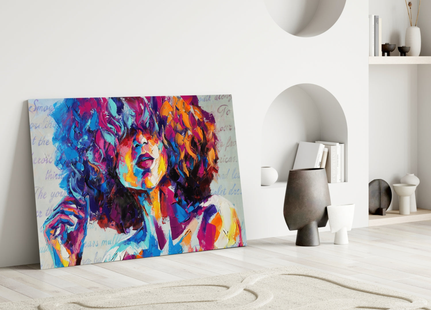 Colorful pop art portrait canvas leaning against white wall in minimalist interior with decorative objects.