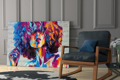 Colorful pop art portrait canvas displayed in modern living room beside wooden rocking chair with black cushions.