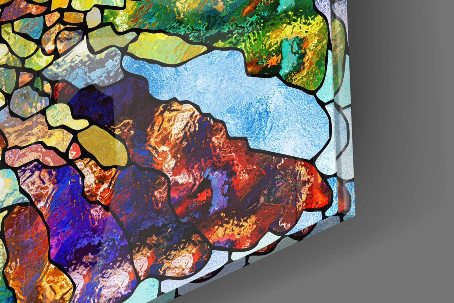 Colorful mosaic glass art with black leading features vibrant jewel tones including blues, reds, purples, and yellows in an abstract stained glass pattern.
