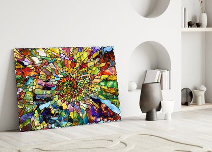 Vibrant mosaic glass art with yellow, red, blue, and green geometric patterns displayed against white wall in minimalist interior.