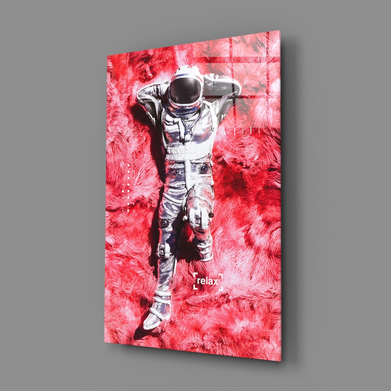 Angled view of glass art panel featuring white astronaut figure against vibrant red textured background with "relax" text.
