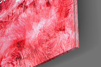 Close-up detail of red and pink textured glass surface with white striations and brushstroke patterns.