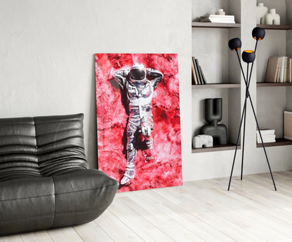 Red and pink Astronaut and Space Grass Glass Art displayed in modern living room with black leather sofa and shelving unit.