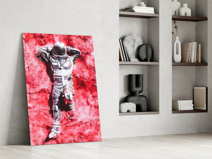 Modern interior styled with vibrant red astronaut canvas leaning against white wall beside wooden shelving units.
