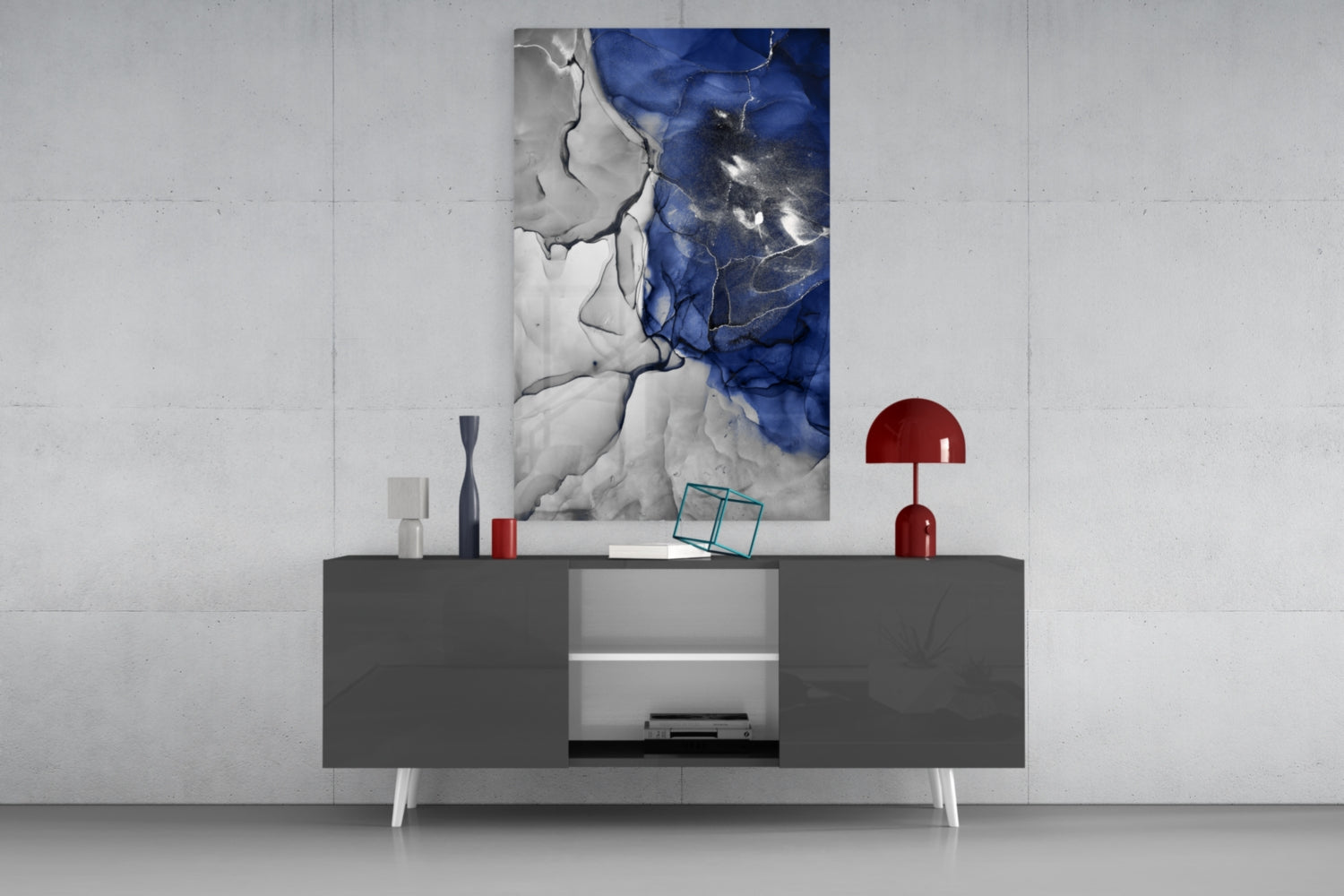 Blue Marble Glass Art displayed on dark gray credenza with white legs, flanked by red decorative objects and accessories.