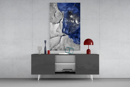 Blue Marble Glass Art displayed on dark gray credenza with white legs, flanked by red decorative objects and accessories.