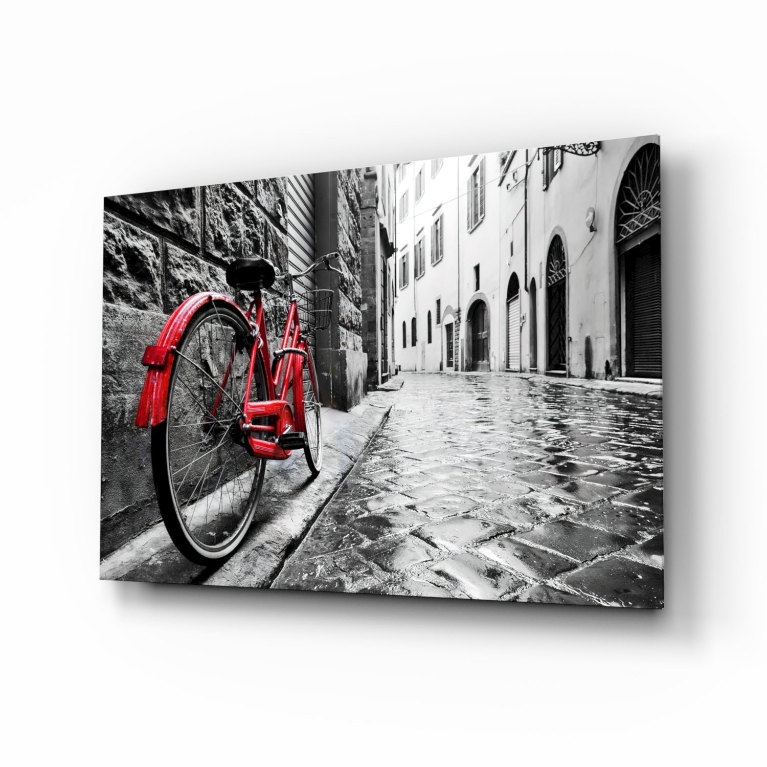 Red vintage bicycle leaning against stone wall in monochrome European street alley, displayed as angled glass art print.