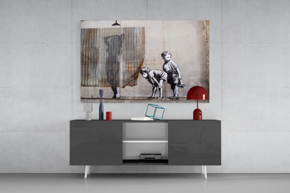 Curiosity Glass Art print displayed above a gray media console, showing children in black and white sketch style with corrugated metal overlay and red accents.