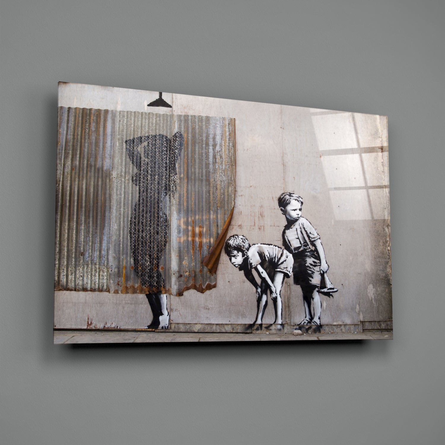 Canvas print showing stenciled figures of two children and a woman with corrugated metal backdrop and window shadows.