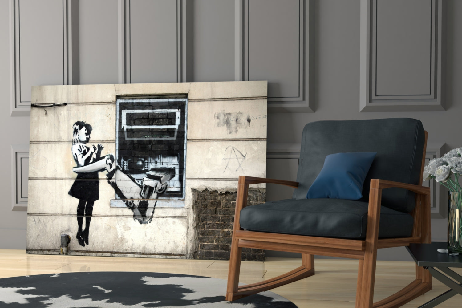 Banksy ATM glass art panel displayed in modern living room beside mid-century wooden chair with black leather cushion.