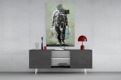 Space Market Glass Art depicting astronaut with colorful blue and yellow wing-like elements displayed on modern gray sideboard.