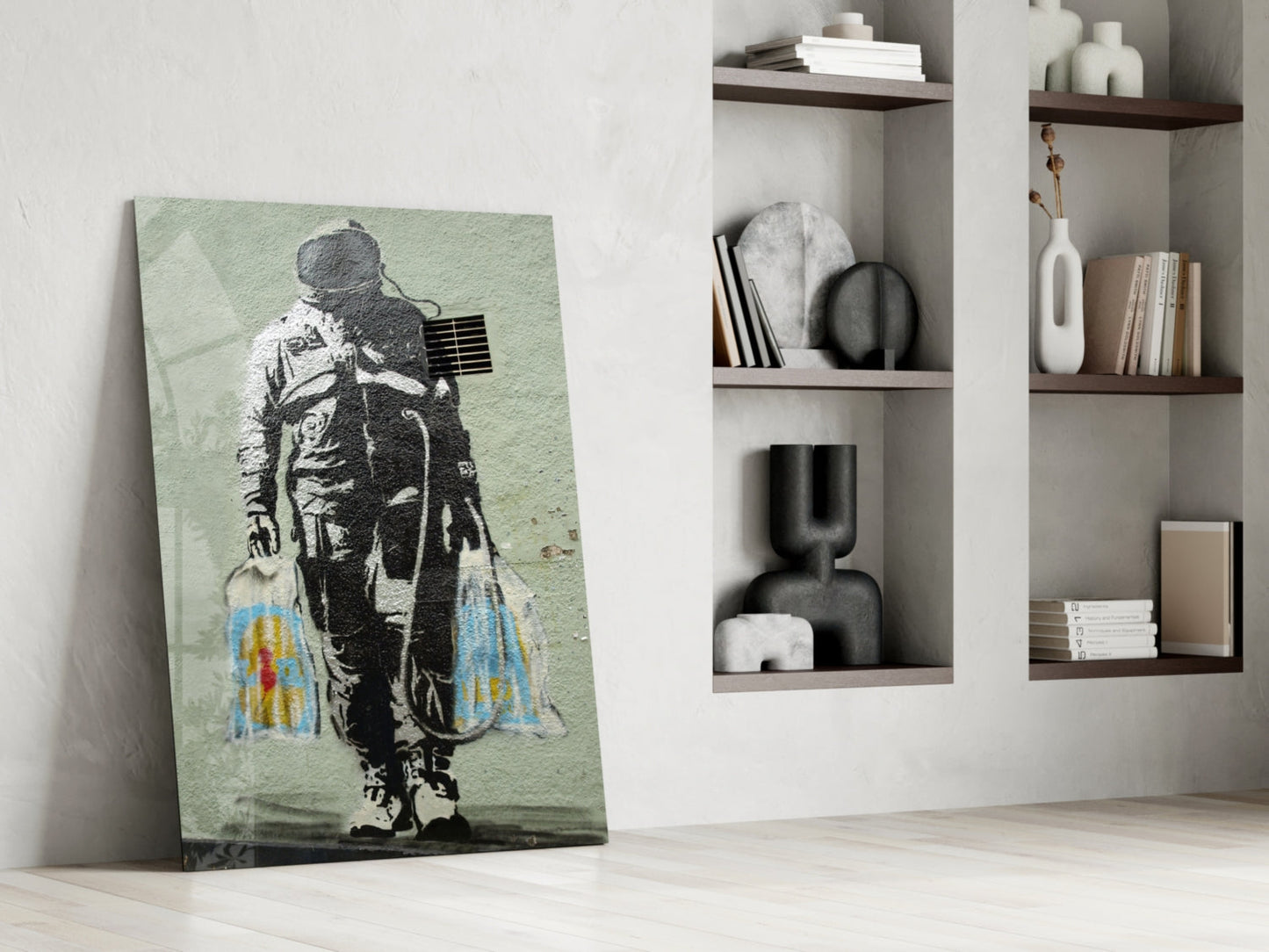 Space Market Glass Art canvas leaning against wall showing astronaut with colorful blue and yellow wings on pale green background.