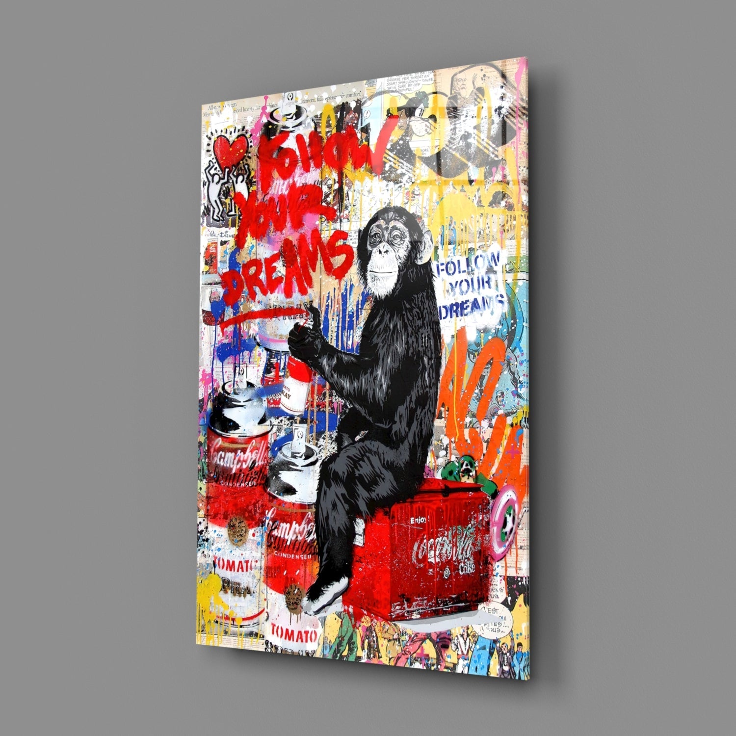 A glass art panel displaying a black chimp sitting on a red Coca-Cola cooler surrounded by colorful graffiti text and pop art elements on gray background.