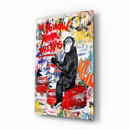 Angled view of colorful mixed-media glass art featuring a black chimpanzee sitting on a red Coca-Cola cooler surrounded by graffiti text and pop art elements.