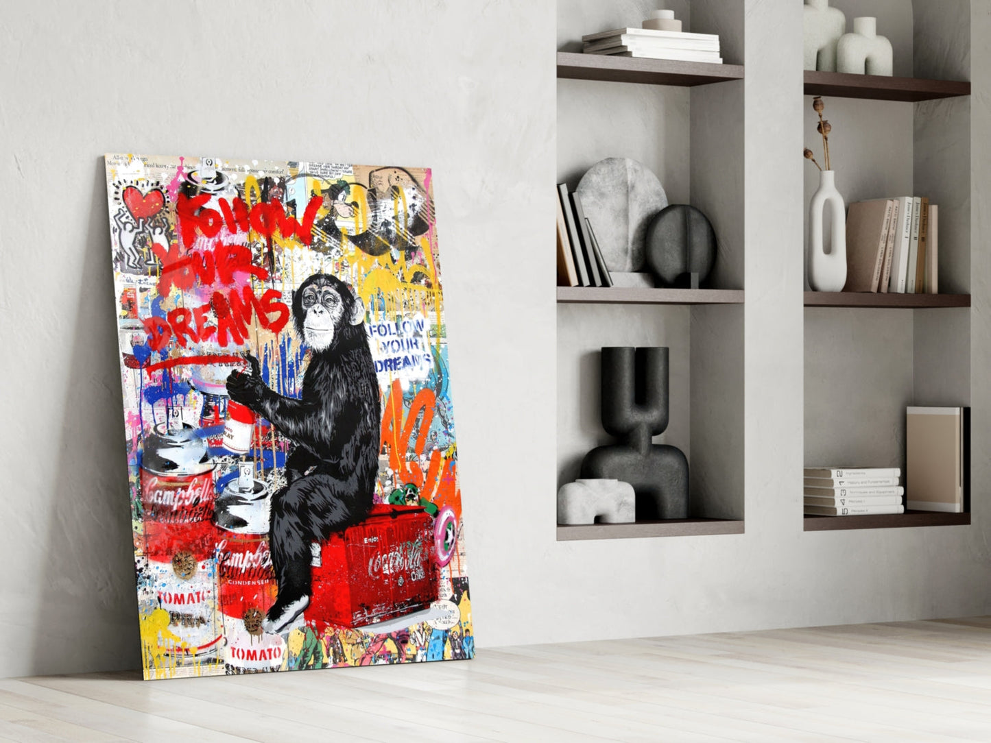 Colorful pop art style glass panel featuring a black chimpanzee surrounded by red graffiti text and Campbell's soup cans, leaning against white wall beside shelving.