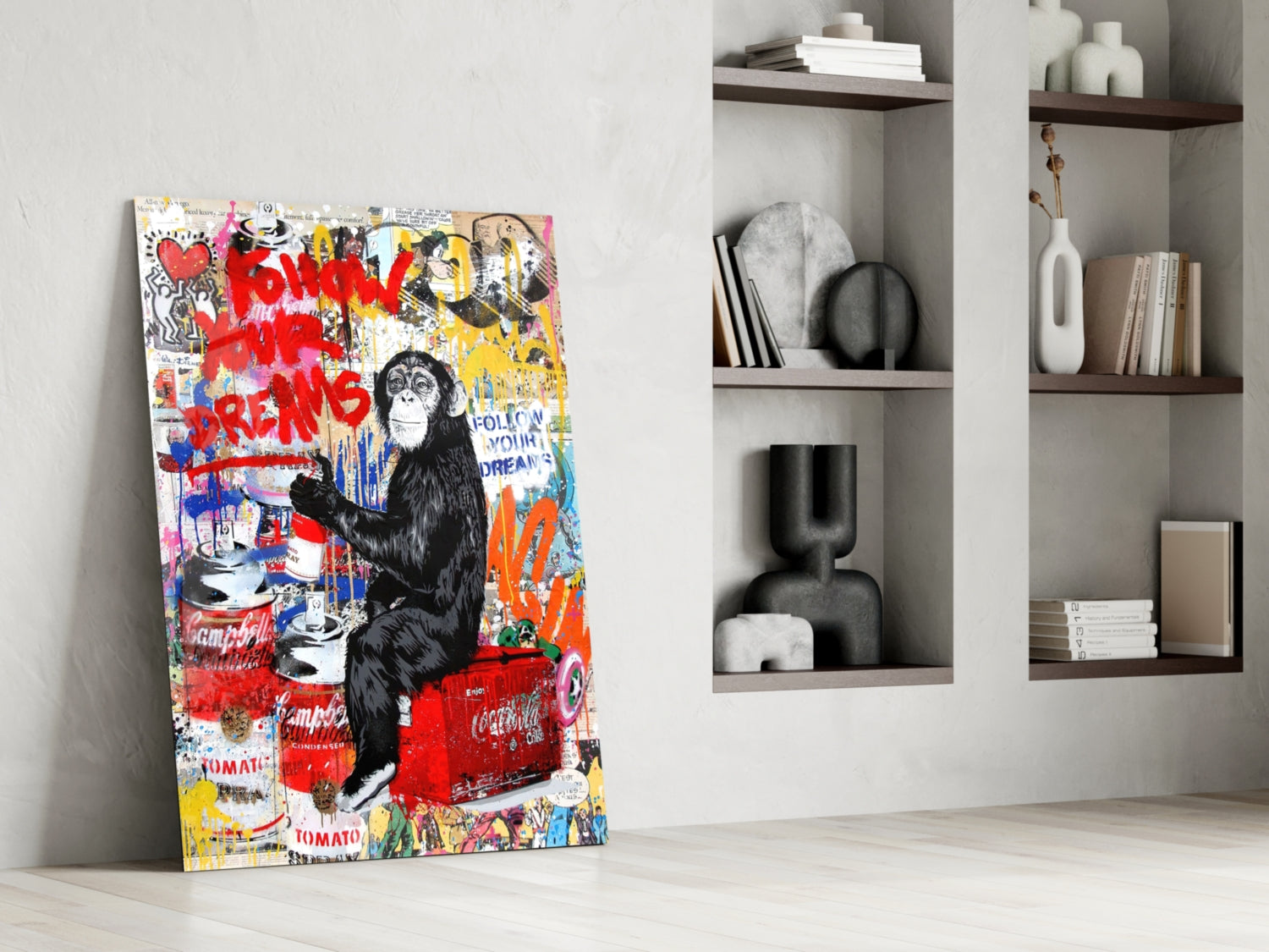 Colorful pop art style glass panel featuring a black chimpanzee surrounded by red graffiti text and Campbell's soup cans, leaning against white wall beside shelving.