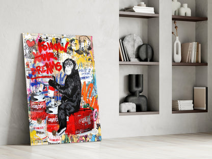 Colorful pop art style glass panel featuring a black chimpanzee surrounded by red graffiti text and Campbell's soup cans, leaning against white wall beside shelving.