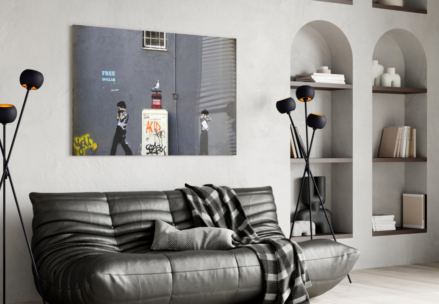 Waiting for Explosion" street art glass print hung above black leather sofa in modern living room with arched shelving.