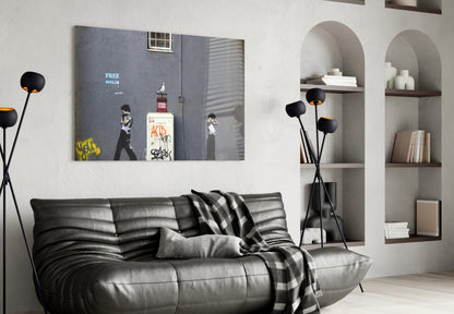 Waiting for Explosion" street art glass print hung above black leather sofa in modern living room with arched shelving.