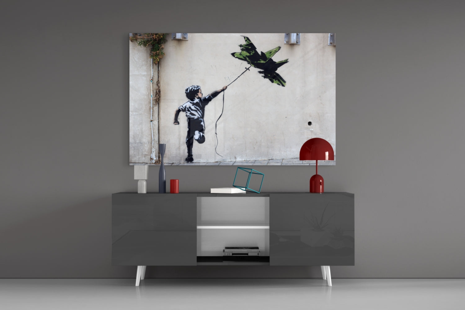 War Kite Glass Art displayed above gray media console showing child with string flying green bird against white wall.