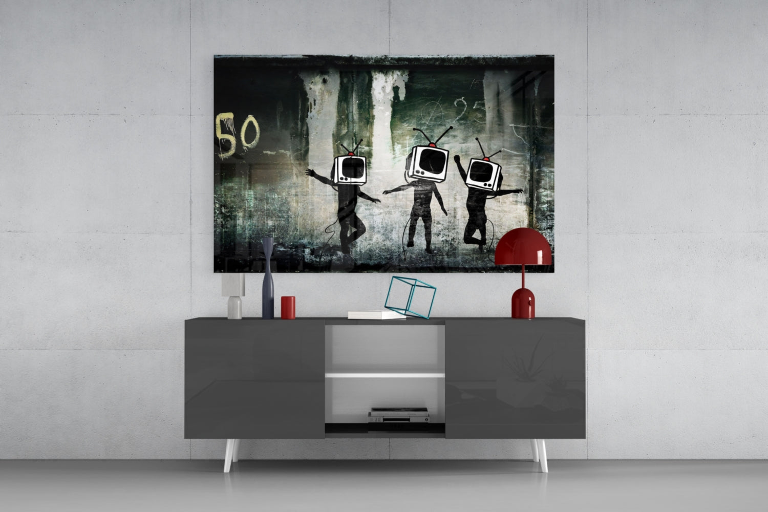 Modern living room setup with TV Heads Glass Art mounted above gray media console, featuring three figures with television screens for heads against distressed urban background.