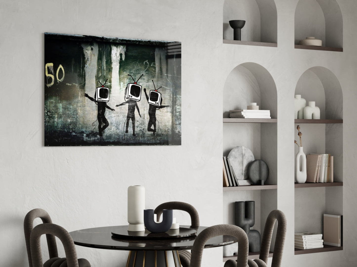 Distressed street art glass panel featuring three black stick figures with television screens for heads against weathered green and gray background with "50" text, displayed above a dining table.