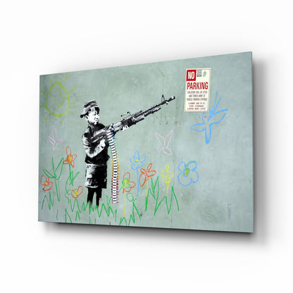 Three-dimensional angled view of glass art panel depicting stenciled child with rifle amid colorful crayon flowers and "No Parking" sign on pale green background.