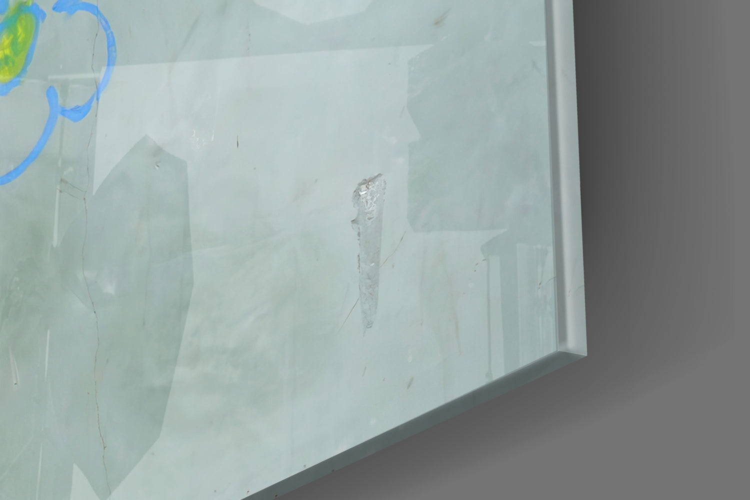 Close-up of frosted glass panel showing etched figure and blue curved lines detail.