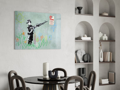 Glass artwork depicting stenciled child figure holding rifle with colorful hand-drawn flowers, displayed above round black table in modern interior.