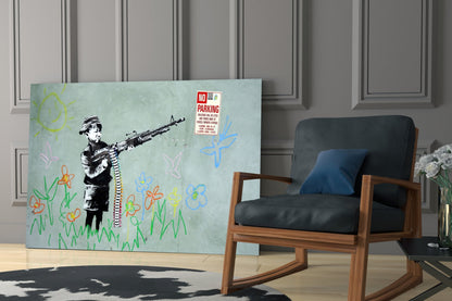 Glass art panel depicting stenciled child with rifle surrounded by colorful drawn flowers, displayed in modern room setting next to wooden chair.