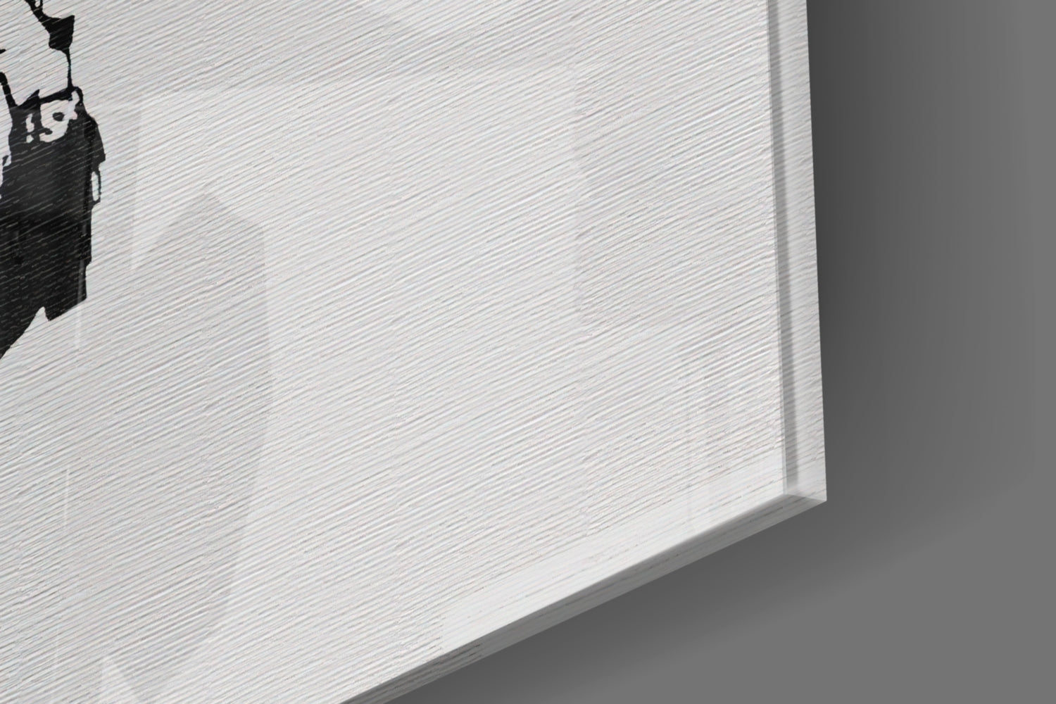 Close-up angled view of white textured glass art piece with black silhouette design in corner.