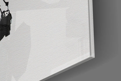Close-up angled view of white textured glass art piece with black silhouette design in corner.