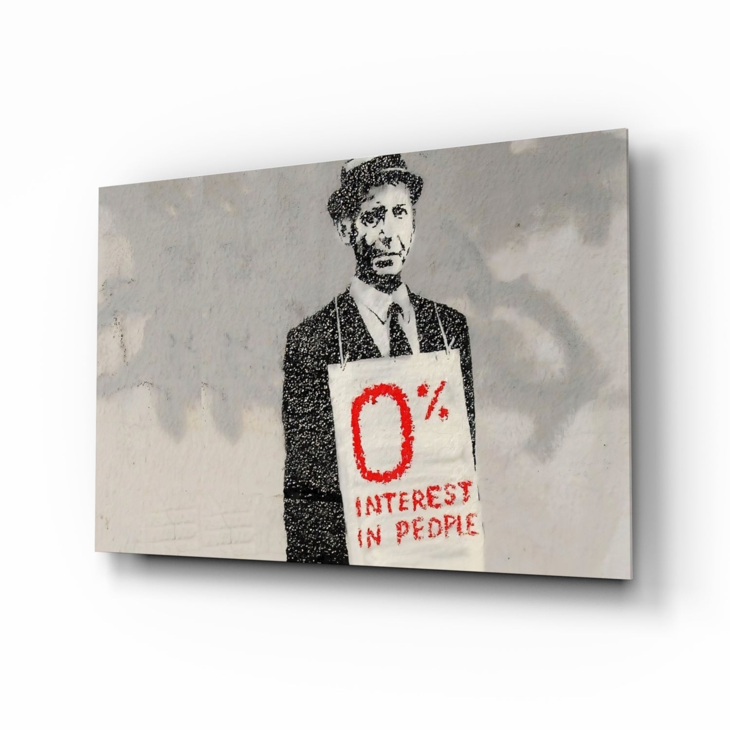 Stenciled portrait of suited man holding sign reading "0% INTEREST IN PEOPLE" in red text on concrete wall art.