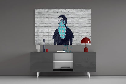 Street art print of figure with turquoise bandana displayed above gray media console with red lamps.