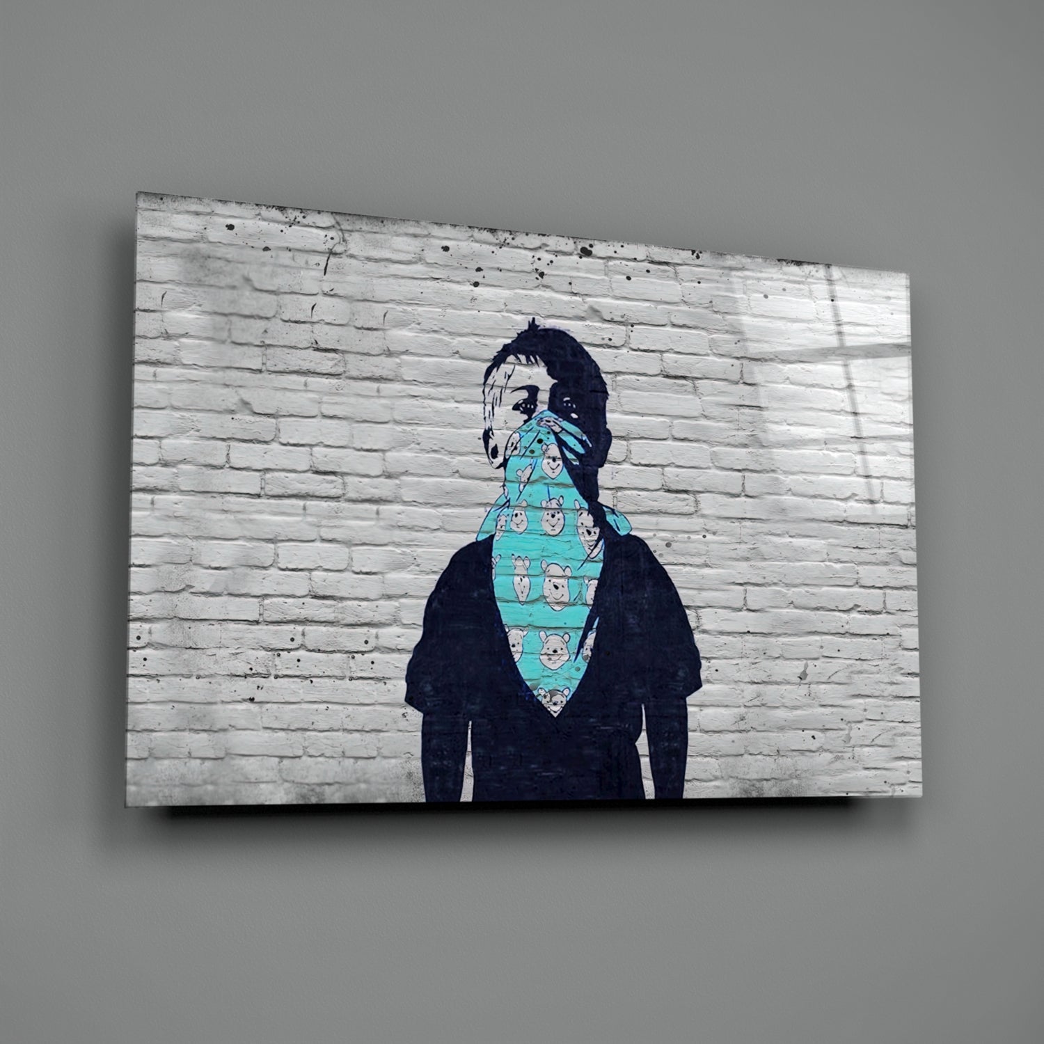 Street art mural on white brick wall depicting figure with face covered by turquoise patterned bandana.