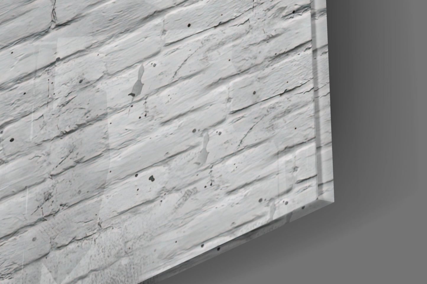 Close-up angled view of white textured glass surface with black speckles and brushstroke patterns.