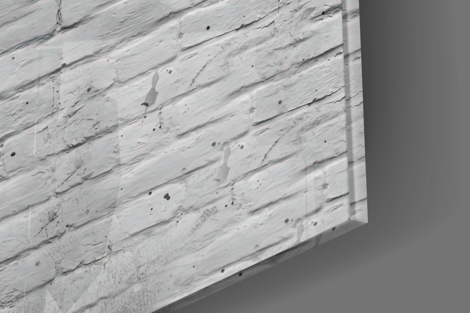 Close-up angled view of white textured glass surface with black speckles and brushstroke patterns.