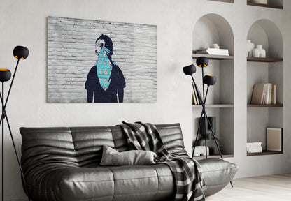 Modern living room with black leather sofa displaying turquoise and navy activist-themed wall art above it.