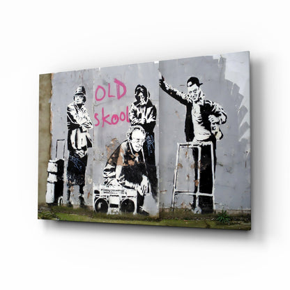 Black and white stenciled figures on weathered gray wall with pink "OLD skool" text, displayed as glass art canvas.