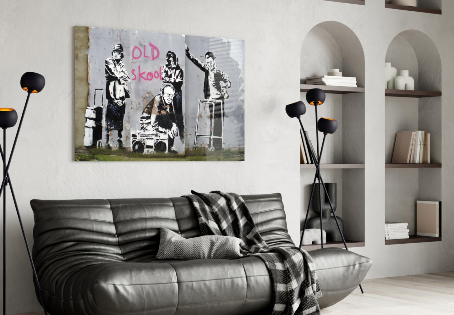 Black and white street art canvas with "OLD skool" text displayed above gray leather sofa in modern living room.