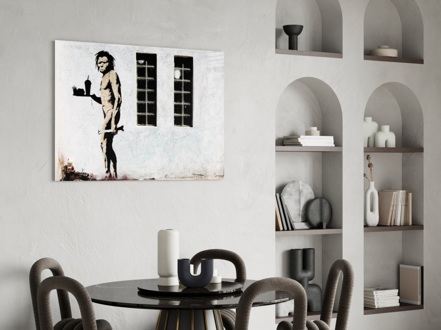 Neanderthal glass art canvas hung above black dining table in modern interior with arched wall shelving.
