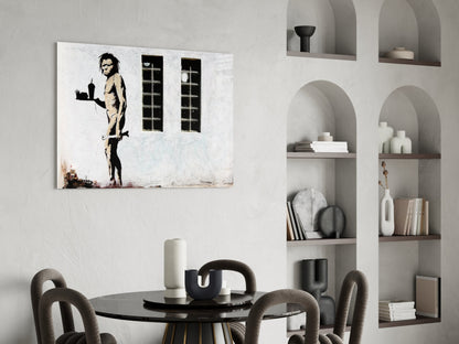 Neanderthal glass art canvas hung above black dining table in modern interior with arched wall shelving.