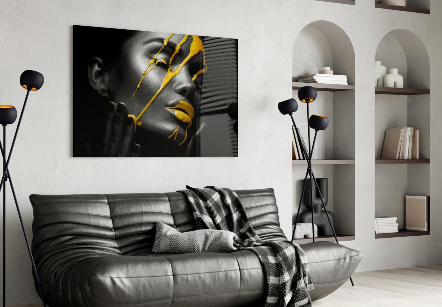 Yellow paint glass art featuring grayscale portrait with gold accents displayed above black leather sofa in modern living room.