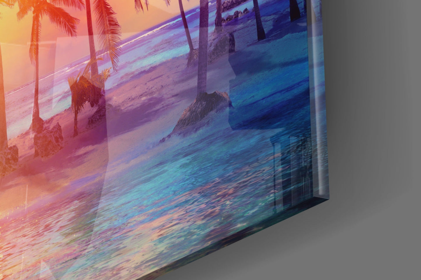 Angled side view of glass art print showing tropical beach sunset with palm trees in warm orange and cool blue gradient tones.