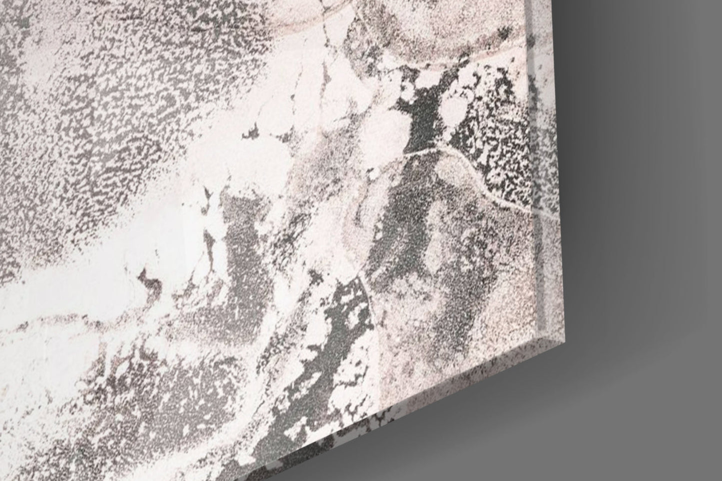 Close-up angle of textured glass surface with pink and white speckled pattern on gray background.