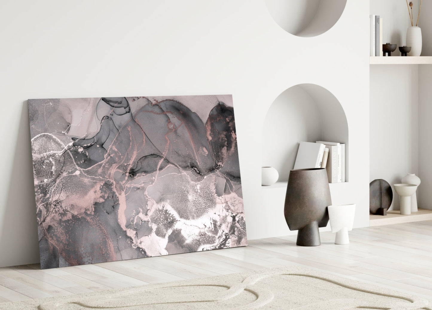 Sweet Pink Glass Art leaning against white wall in minimalist interior with sand, ceramics, and shelving.
