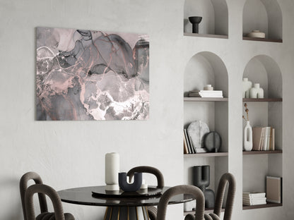 Abstract pink and gray marbled glass art canvas hanging above a black round dining table with curved chairs.