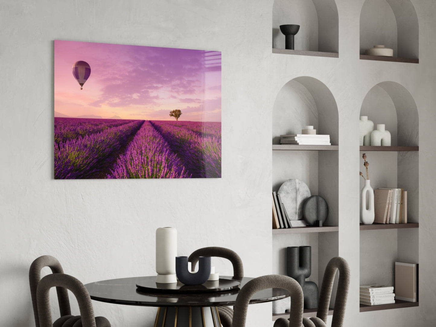 Glass art print of purple lavender field with hot air balloon and solitary tree at sunset, displayed above round black dining table.